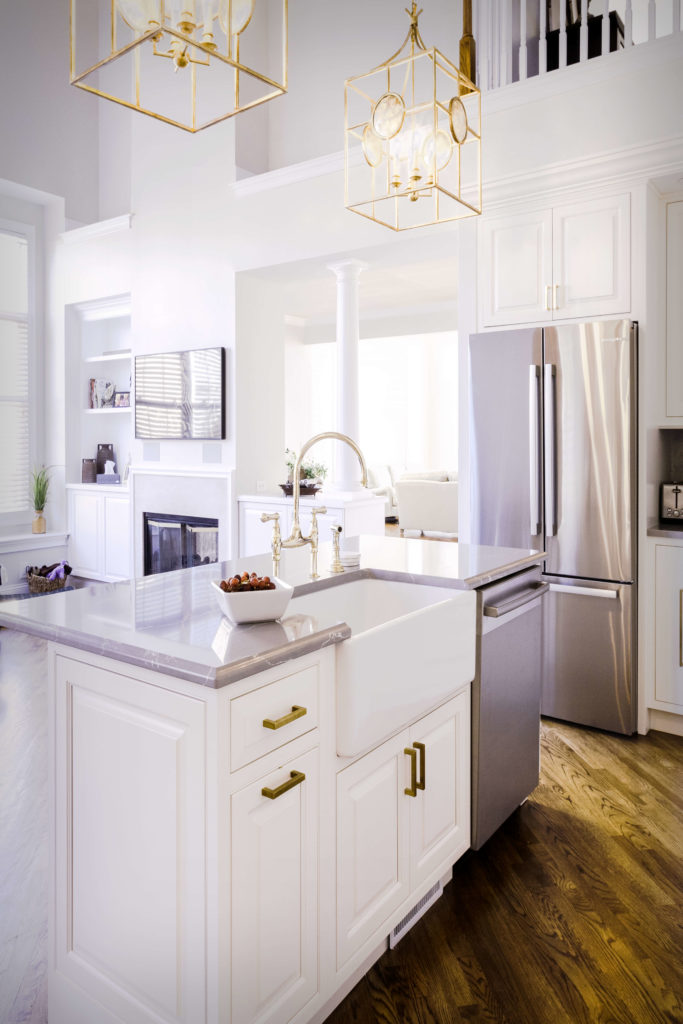 View of island rear with farmhouse sink and countertop, and inset cabinet doors.