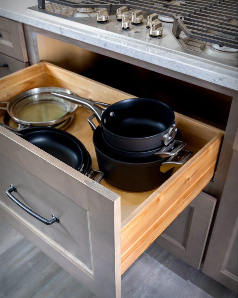 Diamond cabinets can provide extra storage is conveniently located under the stove top.