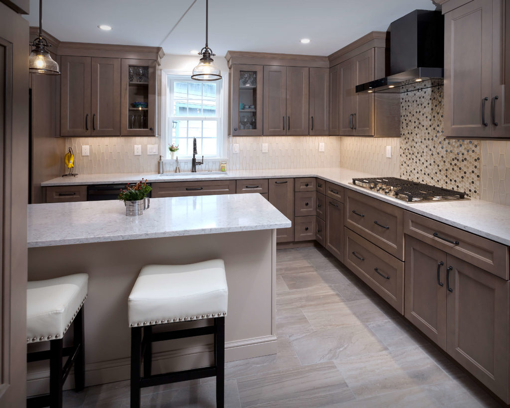 Diamond cabinets in Maple Seal complement the glass tile backsplash.