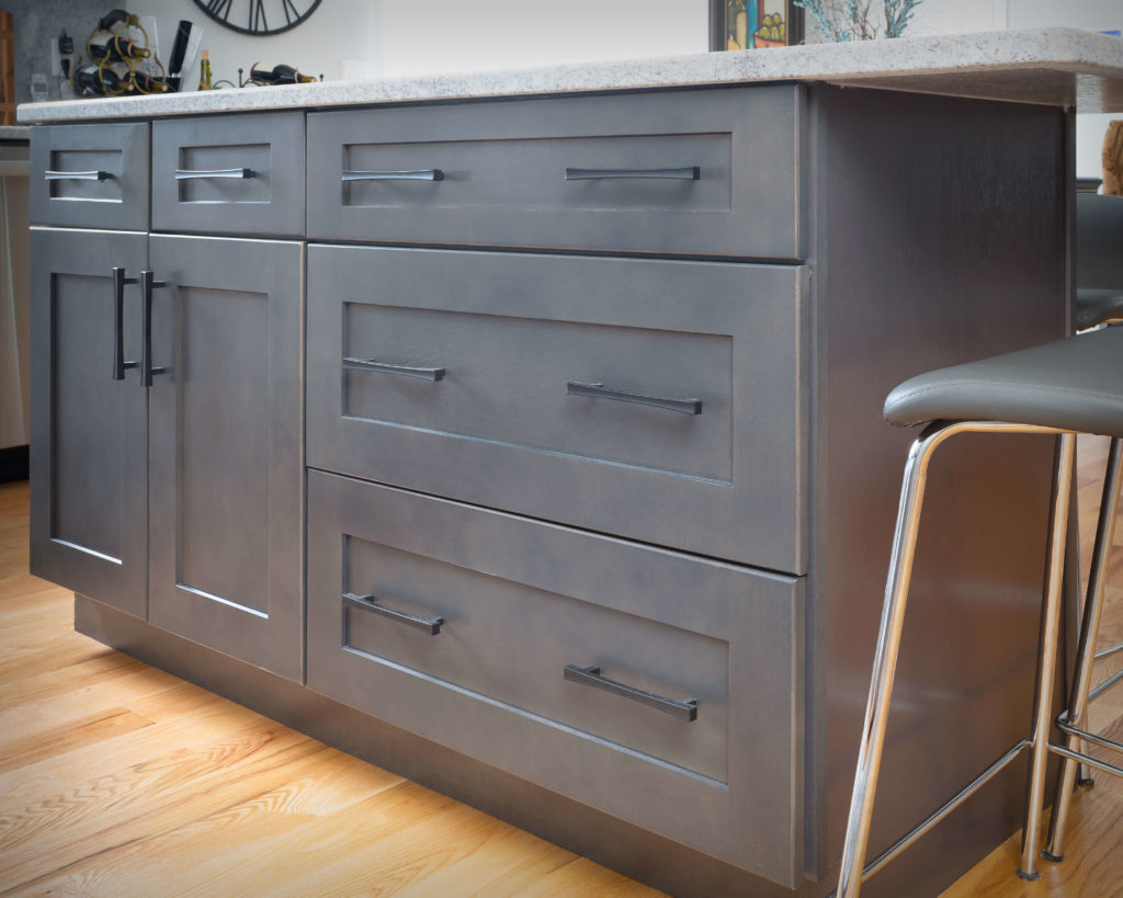 Island counter rear view featuring Matte Black bar pulls in new kitchen and bathroom project in Middletown.