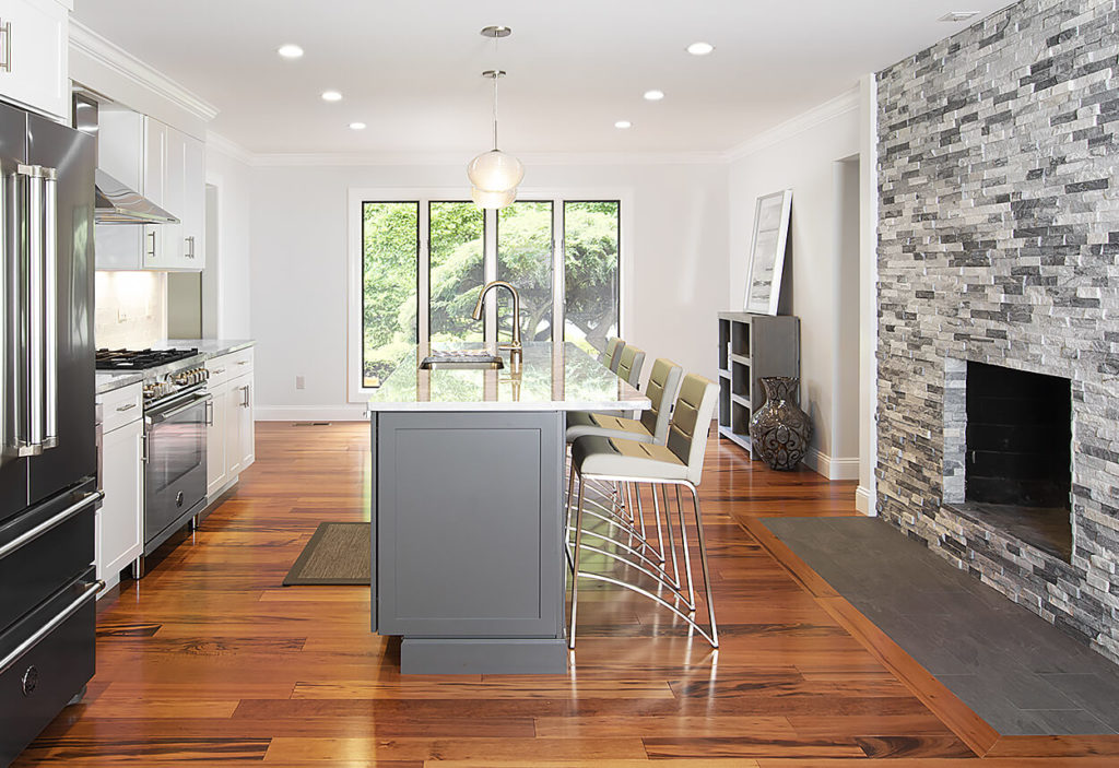 View of the island area AFTER work on this kitchen remodeling West Hartford showing fireplace tile.