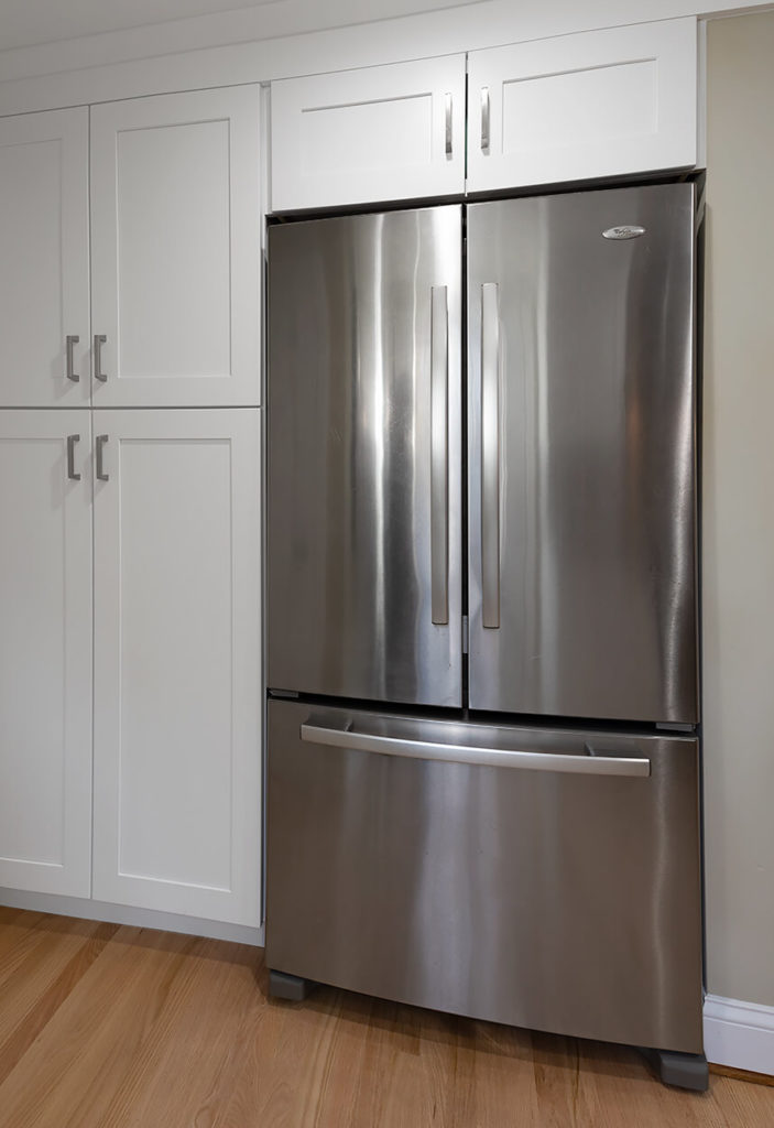 Custom full height cabinets extend to the garage for valuable added storage space.